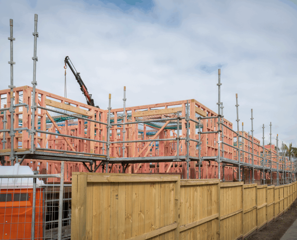Cranes over Auckland skyline representing active urban development and growth opportunities for property investors