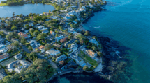 Auckland coastal suburb aerial view with residential housing, highlighting urban development, land use, and housing growth potential in New Zealand