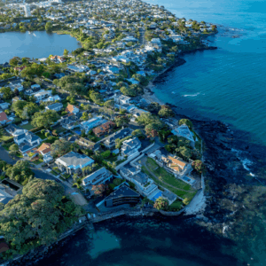 Auckland coastal suburb aerial view with residential housing, highlighting urban development, land use, and housing growth potential in New Zealand
