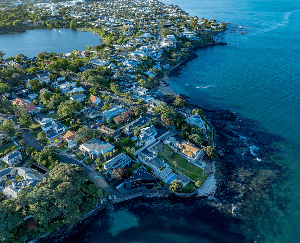 Auckland coastal suburb aerial view with residential housing, highlighting urban development, land use, and housing growth potential in New Zealand